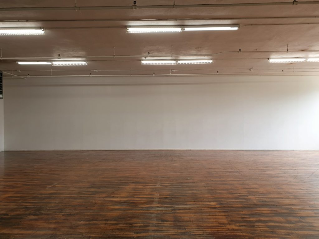 The Movo dance space featuring a white wall and hardwood flooring